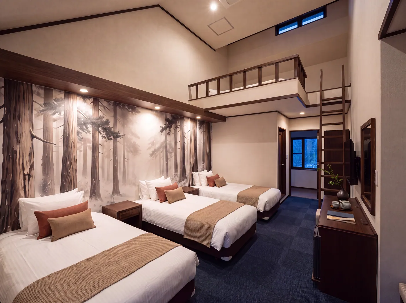 A loft room seen toward the loft platform, ink mural behind the beds